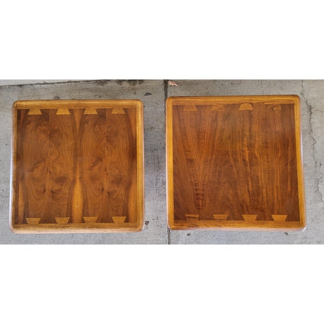 A pair of iconic Lane Acclaim end tables designed by Adre Bus, circa. 1960's. Tapered legs with the large dovetail design...