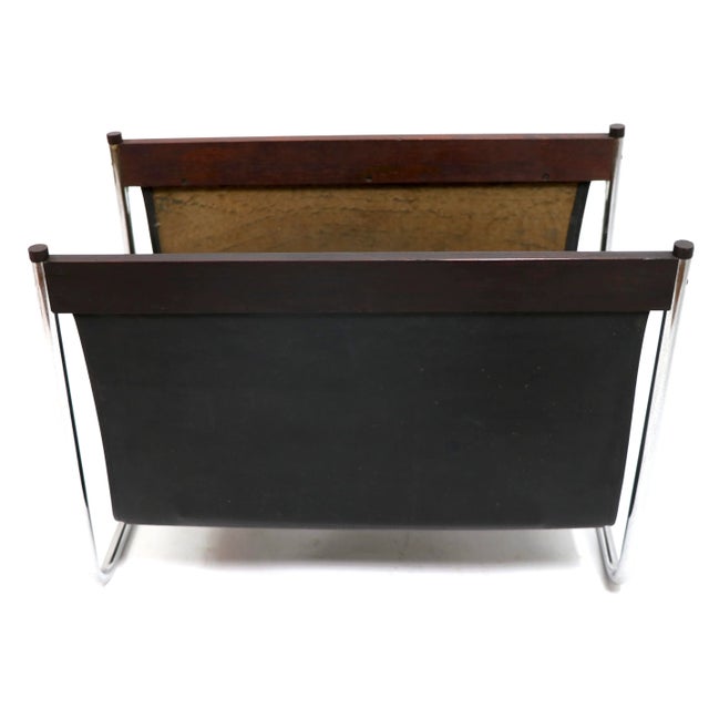 Chic stylish vintage magazine rack, catch all sling. The frame is of tubular chrome, with rosewood elements supporting the...