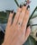 A pear-shaped natural alexandrite takes center stage in this solid 14K white gold ring, encircled by a lavish halo of...