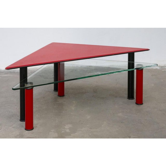 Particular composition of two triangular tables from the 80s The first element has a shelf covered in leather and rests on...