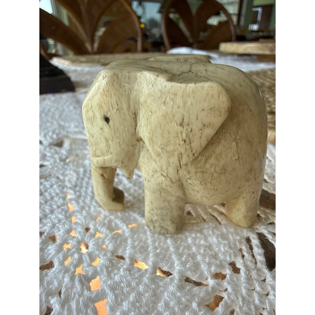Mid Century Modern Minimalist Elephant hand-carved in bovine bone featuring an off-white warm hued patina reflective of...