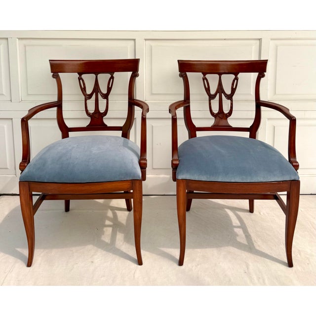 Here is an elegant set of six neoclassical dining chairs from the late 20th century, defined by beautifully carved backs...