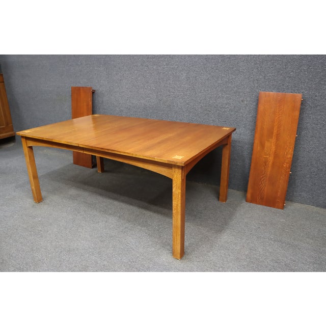 A Stickley Harvey Ellis Mission dining table crafted in quarter-sawn oak with the clean lines and refined craftsmanship...