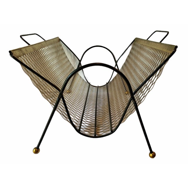 Vintage Mid-Century Modern magazine rack dating to the mid-20th century. This stylish piece features a perforated brass-...