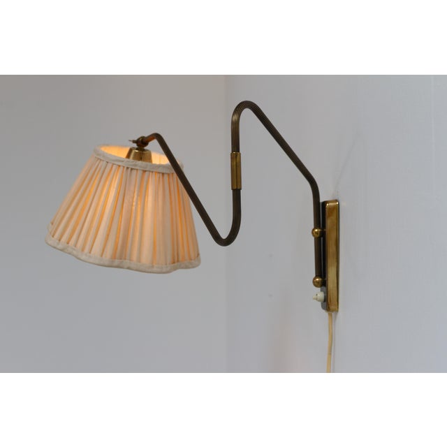 Danish designer articulating brass wall light by teknika, denmark 1950s. scandinavian mid-century modern adjustable brass...