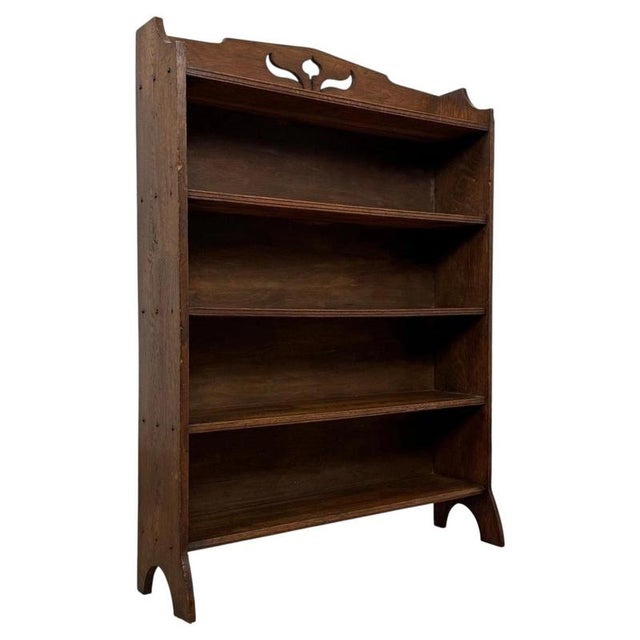 A handsome and well-crafted early 20th-century English open bookcase in the Arts and Crafts tradition, constructed in oak...