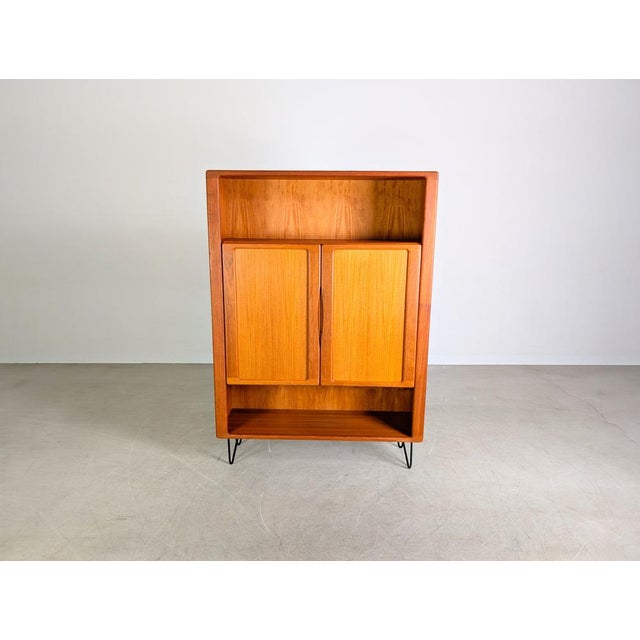 One of two beautiful vintage cabinets from the 1960s/1970s. The piece features two large doors and two open compartments...