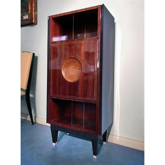 This secretaire cabinet was made in the 1950s and is reminiscent of designs by Paolo Buffa. The teak veneered structure...