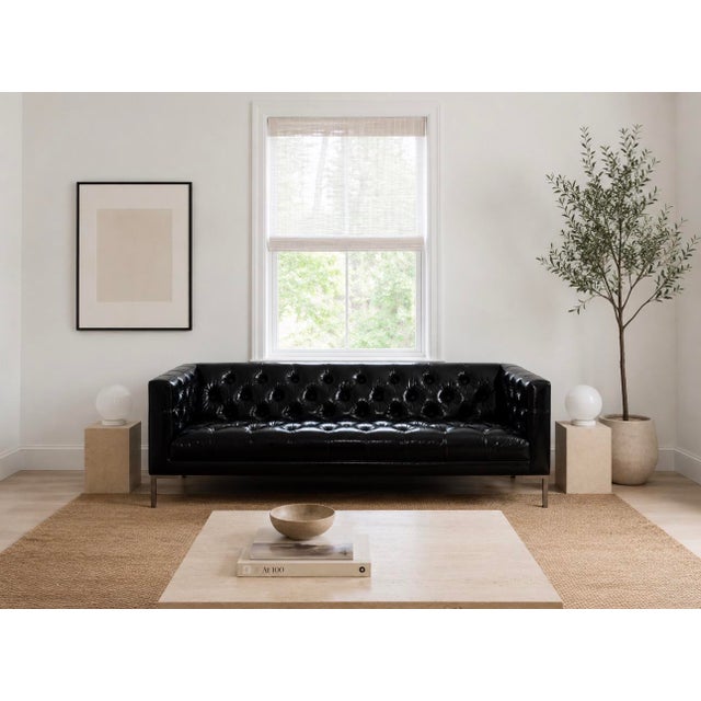 This is not your average tufted sofa. Custom-made in ultra-premium Edelman patent leather, this dramatic tuxedo-style sofa...