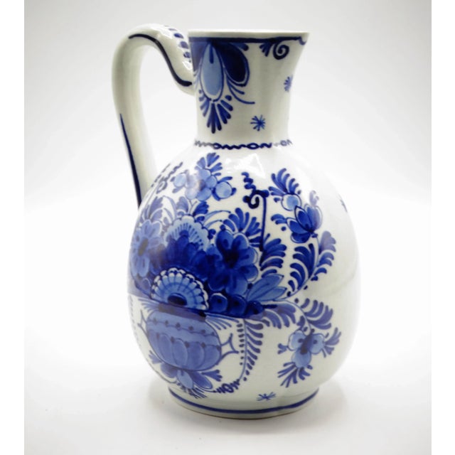 Antique Dutch Delft faience blue and white jug. This lovely early 20th-Century pitcher is hand painted in traditional...