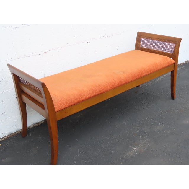 This charming Bench is made of wood, caning, and upholstery. This lovely Bench has Mid century style, it features a...