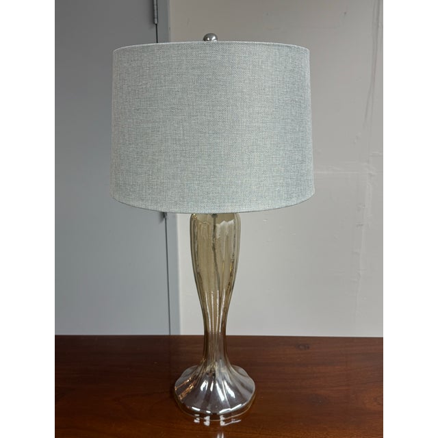 Design Plus Gallery presents the Gable Glass Table Lamp from Bassett Furniture. The reflective glass body displays smoky...