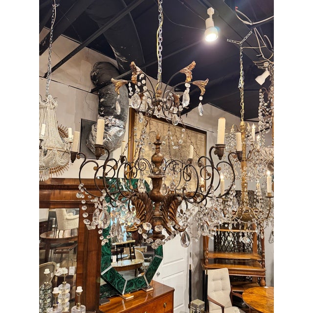 The 19th c. Italian Tuscan Iron and Giltwood Chandelier is a stunning lighting fixture perfect for any room. Interesting...