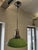 An attractive single-bulb pendant light from the 1960s, with a green glass shade and chrome suspension. The lamp is in...