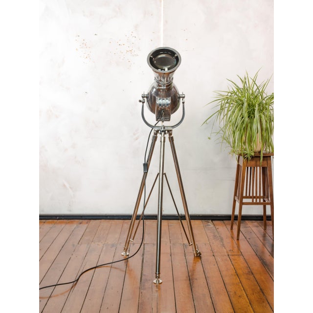 A strand electric patt 23n spotlight from the 1960s, made in england, polished throughout and mounted on a chrome tripod....