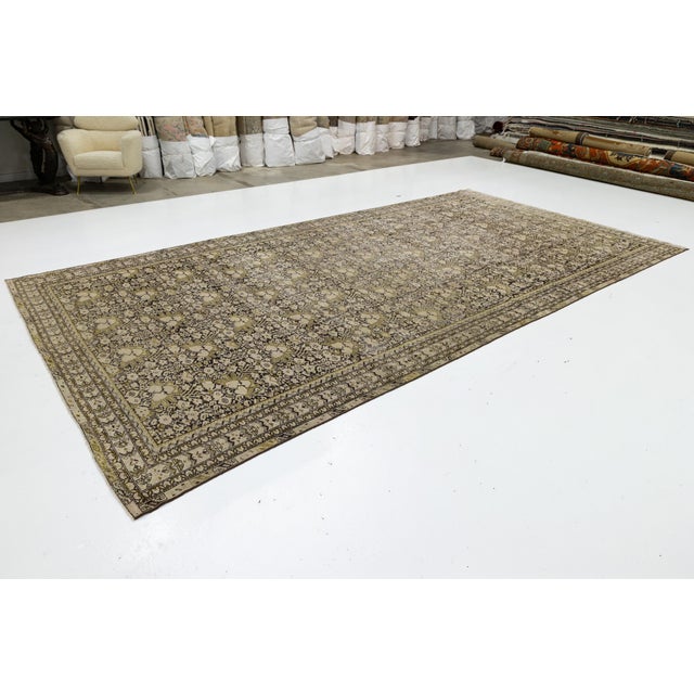 This elegant antique Malayer rug from Northwest Persia features a finely woven floral and vine lattice in muted beige,...