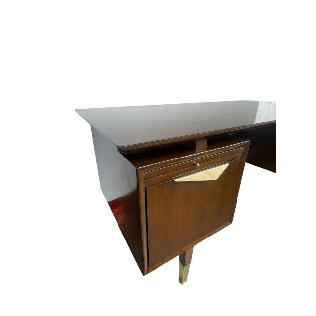 A striking MCM Danish executive desk from the 1960s, expertly crafted from rich walnut and featuring a sophisticated...