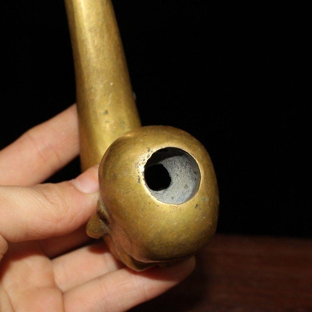 This is a unique and charming vintage Chinese brass tobacco pipe, crafted from polished brass. The piece features a...