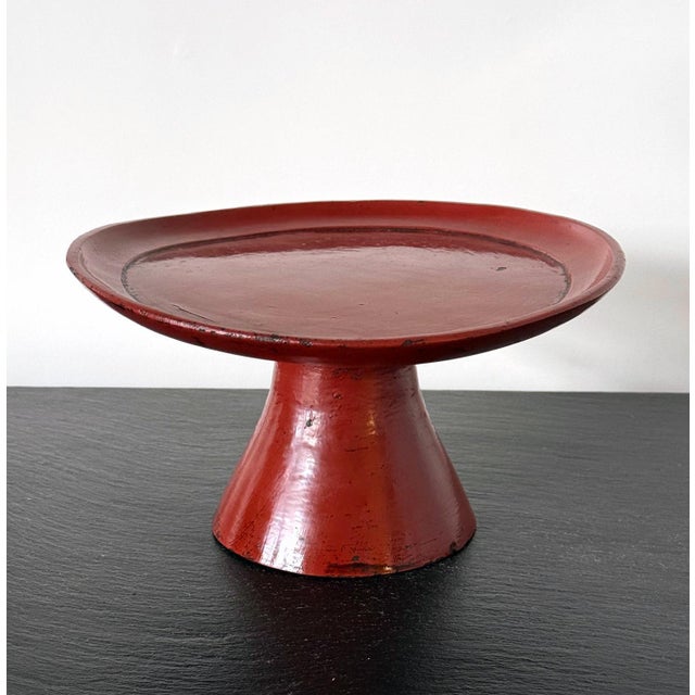 An antique red lacquer stem dish from Japan, circa 17th century (Momoyama to early Edo period). This type of red lacquer...