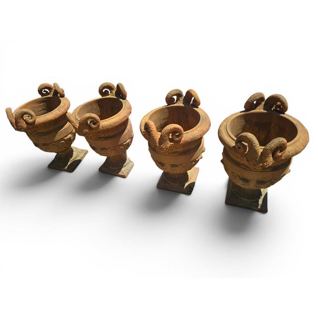 Exceptional set of four decorative urns crafted in renowned Impruneta terracotta, Italy, during the 1960s. Richly...