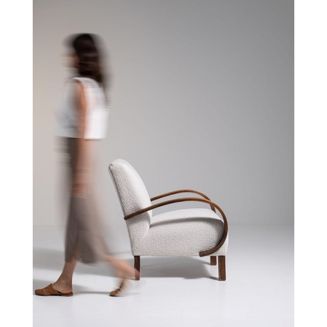 Bentwood-arm lounge chair in Warm Ivory Boucle. The warm ivory boucle surface highlights curved wood open arms, ivory...