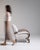 Bentwood-arm lounge chair in Warm Ivory Boucle. The warm ivory boucle surface highlights curved wood open arms, ivory...