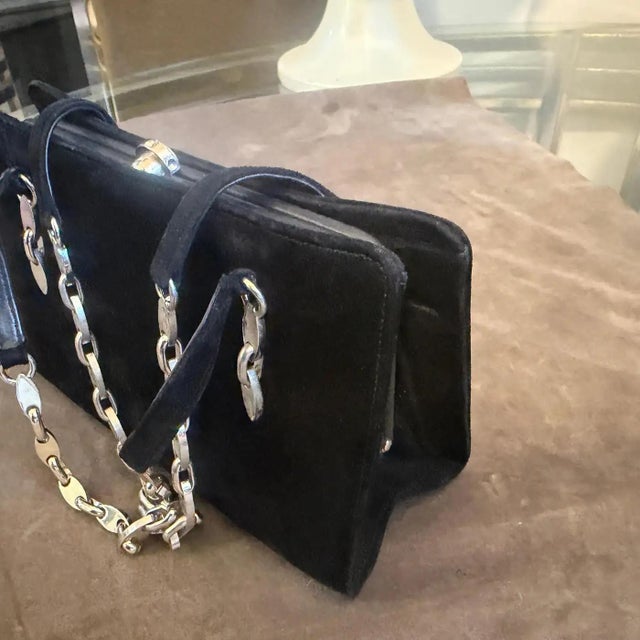 This sophisticated 1980s Italian evening bag is a stunning example of late-century luxury, combining tactile textures with...