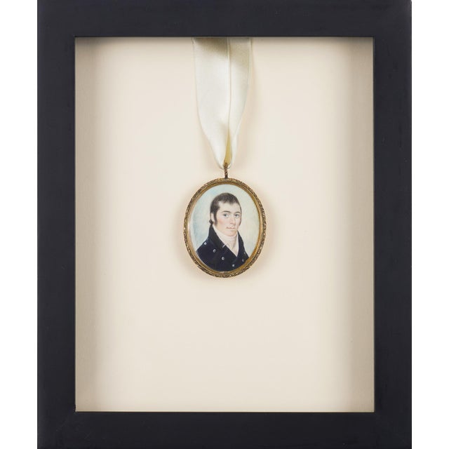 A gentleman's portrait miniature, hand-painted on bone and set in a gilt brass bezel with display loop, likely from Boston...