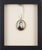 A gentleman's portrait miniature, hand-painted on bone and set in a gilt brass bezel with display loop, likely from Boston...