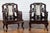 A pair of Chinese hand carved rosewood armchairs from the early 20th century with inset marble splats and dark patina. We...
