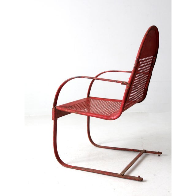 This mid-century metal patio chair features an iconic perforated design, complemented by a sturdy cantilever base. The...