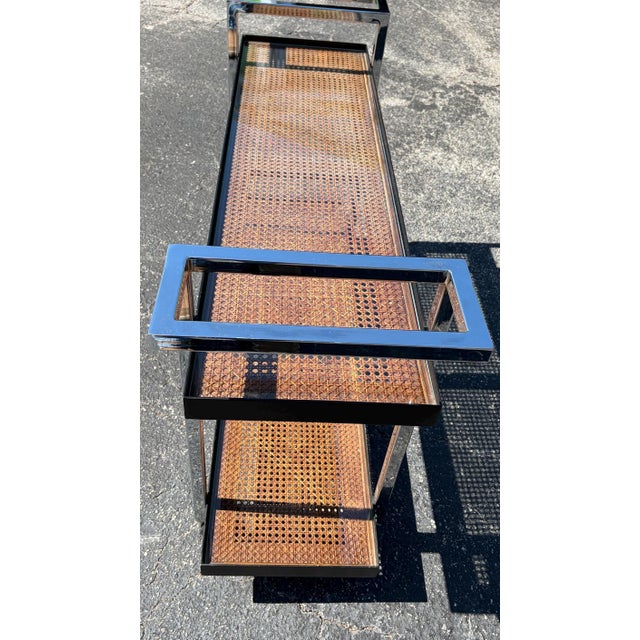 This is an incredible Mid Century bar cart. It features heavy shiny chrome handles. There are two levels of beautifully...