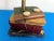 Chic petite 1970s trompe l'oeil accent lamp of painted and incised resin designed to look like a random stack of books...