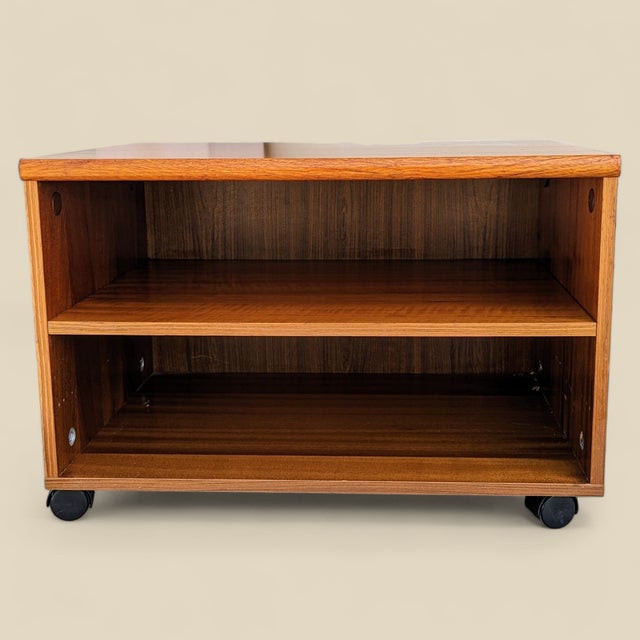 Vintage Teak Rolling Cabinet or End Table. A low vintage teak cabinet on caster wheels with an open shelf and compact...
