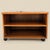 Vintage Teak Rolling Cabinet or End Table. A low vintage teak cabinet on caster wheels with an open shelf and compact...
