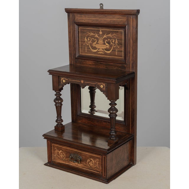A 19th century English Edwardian vitrine constructed using rich, finely grained rosewood with contrasting satinwood...