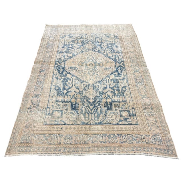 This elegant antique rug is distinguished by its large stylized central medallion and refined early 20th-century...