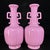 A lovely pair of Chinese monochrome porcelain vases featuring a vibrant, glossy pink glaze. The vases have a faceted,...
