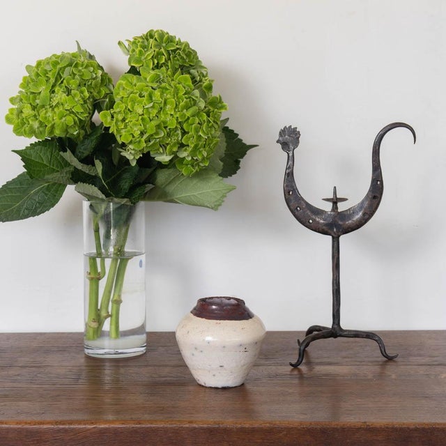 Lovely iron rooster candlestick from France, 1950s. Forged iron rooster motif with stem resting on a tripod base. Wrought...