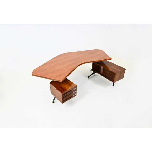 Boomerang-shaped wooden and metal desk. Stamped Tecno. Two modules, one with three drawers and the other with three...