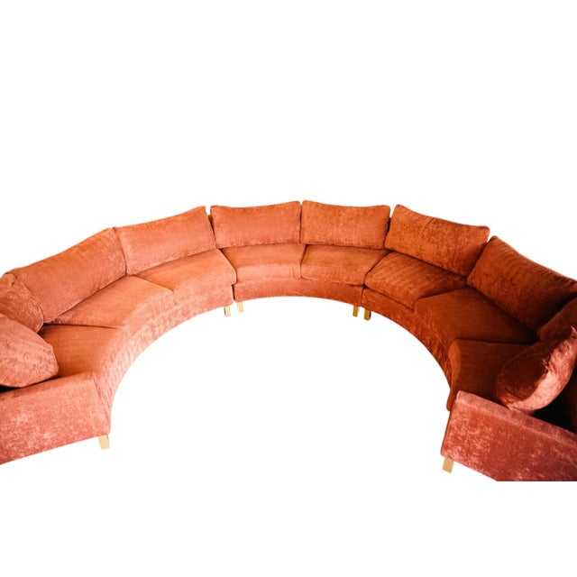 A dramatic curved serpentine sectional in rich sienna chenille, designed to anchor a room with its sweeping silhouette and...