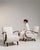 A cream wood armchair by Jindřich Halabala, dating to the 1950s and made in Czechia. The wood frame is finished in fabric,...