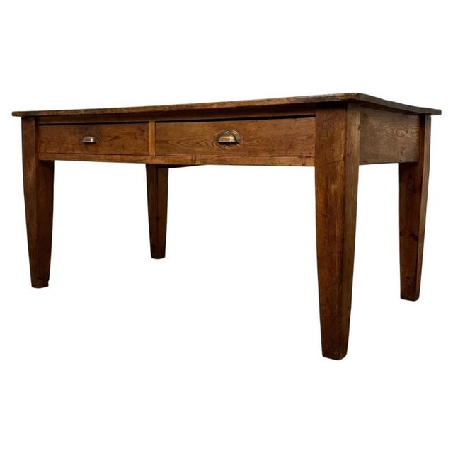 A handsome and substantial 19th-century English farmhouse writing table, beautifully constructed in pine and distinguished...