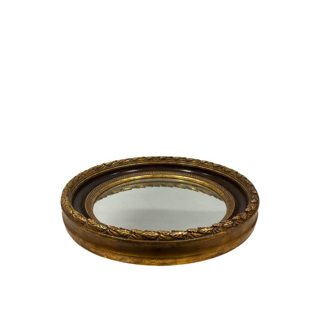 Designer round mirror with gilded leaf motif border