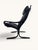 Siesta armchair by Norwegian designer Ingmar Relling. The black leather features a beautiful tufted finish and rests on a...