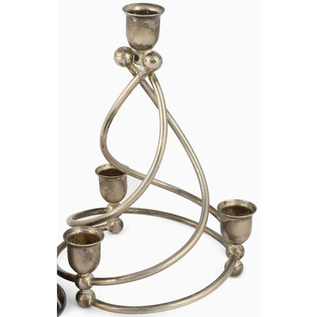 Two spiral candlesticks is an original decorative pair of objects realized in the 1920s. Original silver plated metal. The...