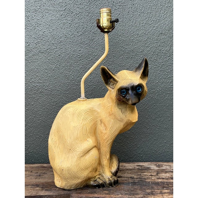 This charming vintage table lamp is a quintessential example of mid-century figural decor, blending whimsical kitsch with...