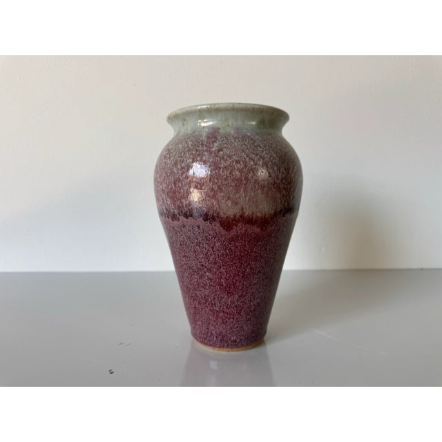 A striking studio pottery vase signed and dated M. Ritchie, 1990. This handcrafted piece showcases a classic baluster form...