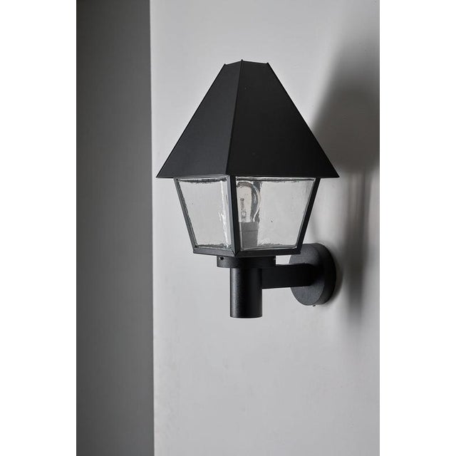 This outdoor wall lantern comes from the exclusive "Boom" collection by BEGA. Unlike BEGA's modern architectural lines,...