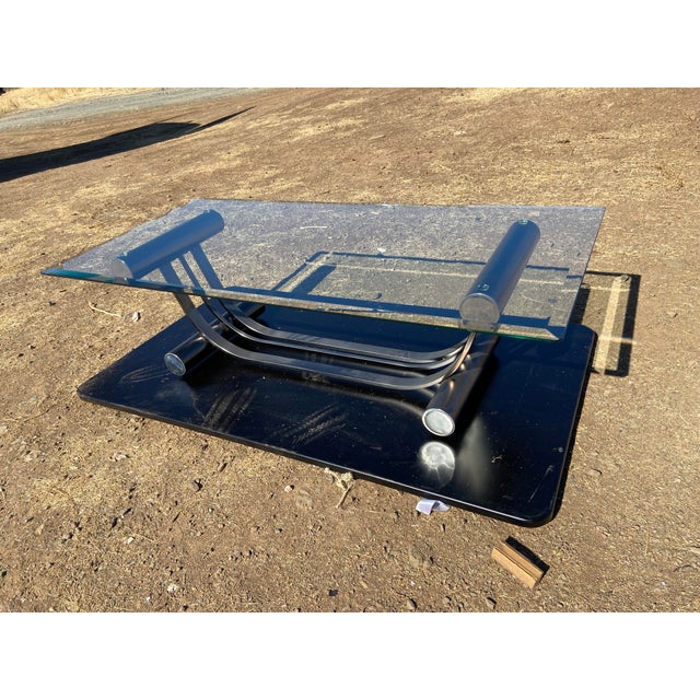 This Vintage Art Deco Tubular clear Glass coffee table attributed to Romeo Rega features a stylish and unique design with...